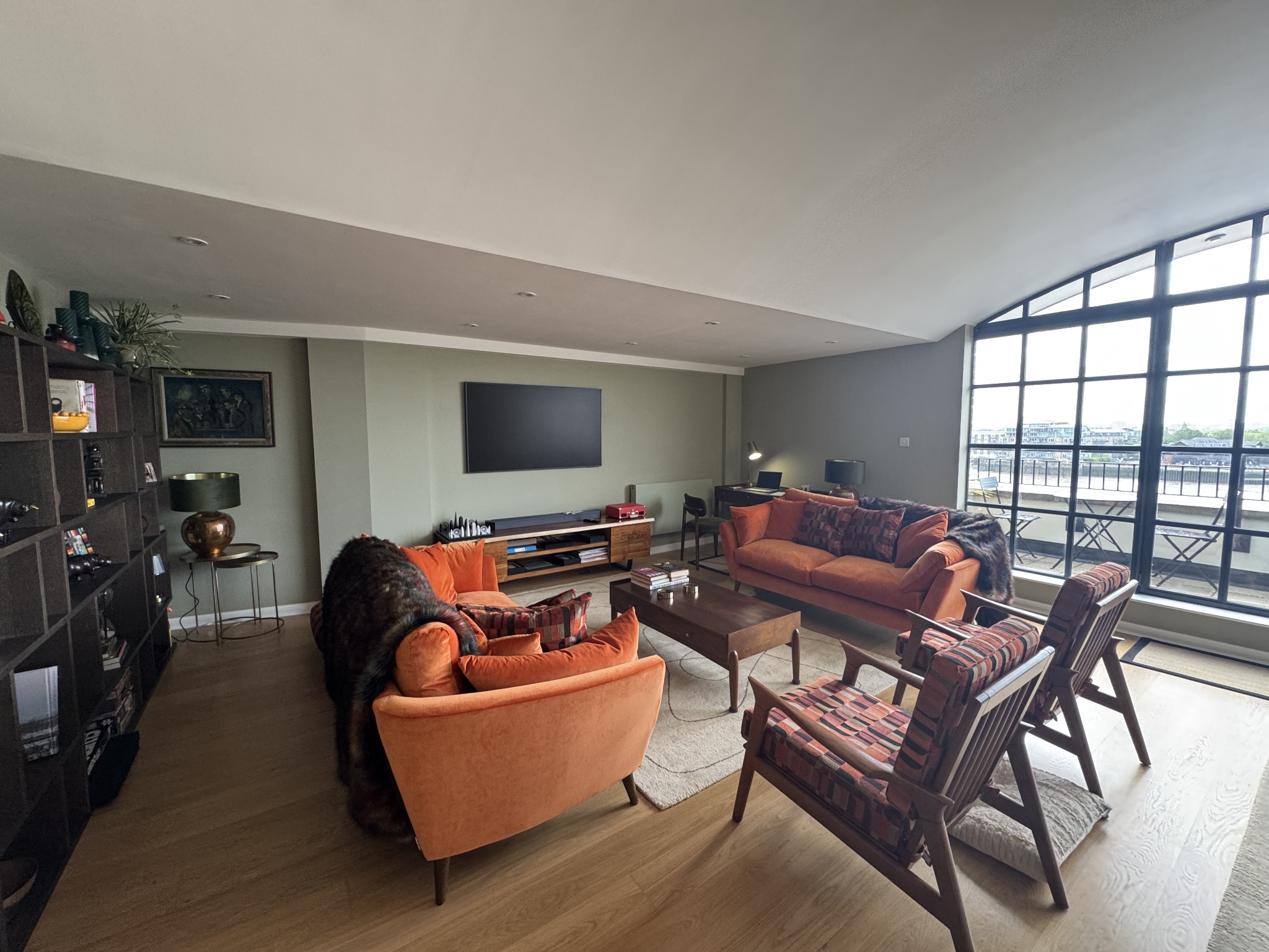 Completed living room interior with full-height industrial-style windows